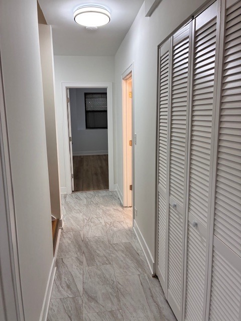 8010 South Ridgeland Avenue, Unit 1D Chicago, IL 60617 - Photo 16 of 28 a view of hallway with bathroom and a sink