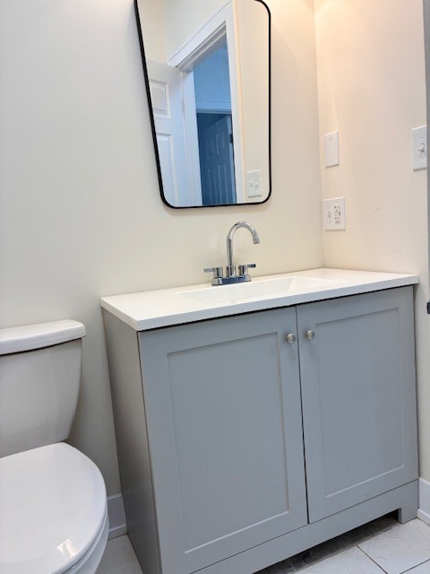 8010 South Ridgeland Avenue, Unit 1D Chicago, IL 60617 - Photo 22 of 28 a bathroom with a toilet sink and mirror