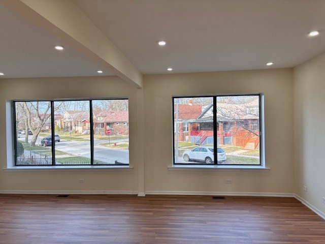 8010 South Ridgeland Avenue, Unit 1D Chicago, IL 60617 - Photo 3 of 28 an empty room with wooden floor and windows