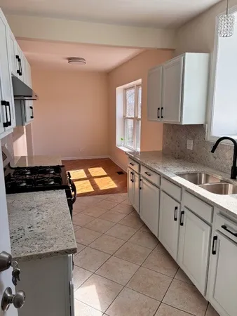 a kitchen with stainless steel appliances granite countertop a sink stove and cabinets