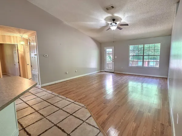 a view of a livingroom with a ceiling fan and window