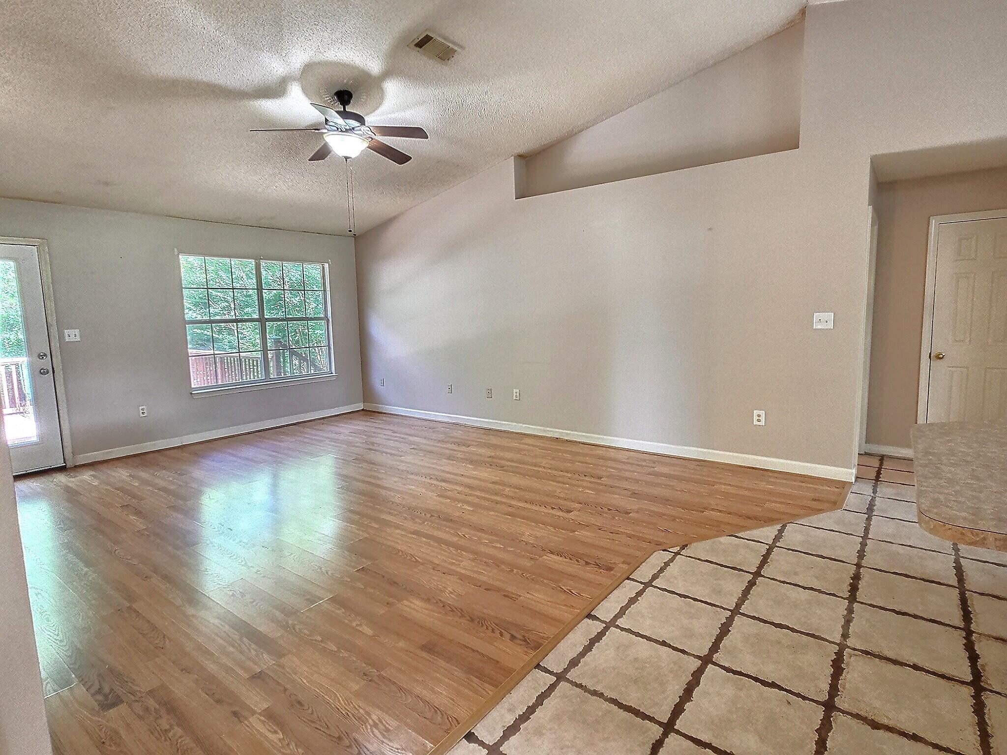 4868 Orlimar Street Crestview, FL 32536 - Photo 14 of 25 an empty room with windows and ceiling fan