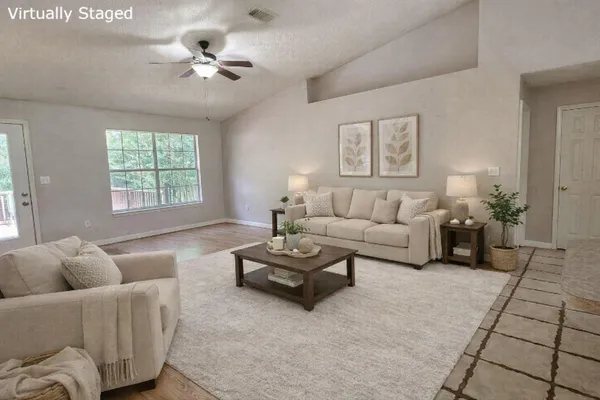 a living room with furniture and a large window