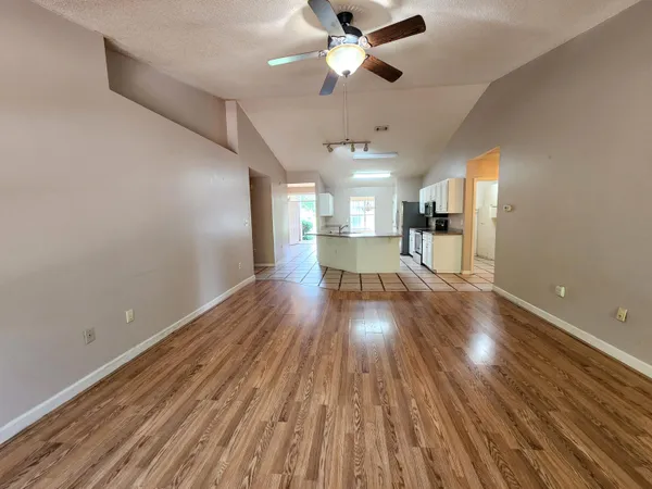 a view of empty room with wooden floor