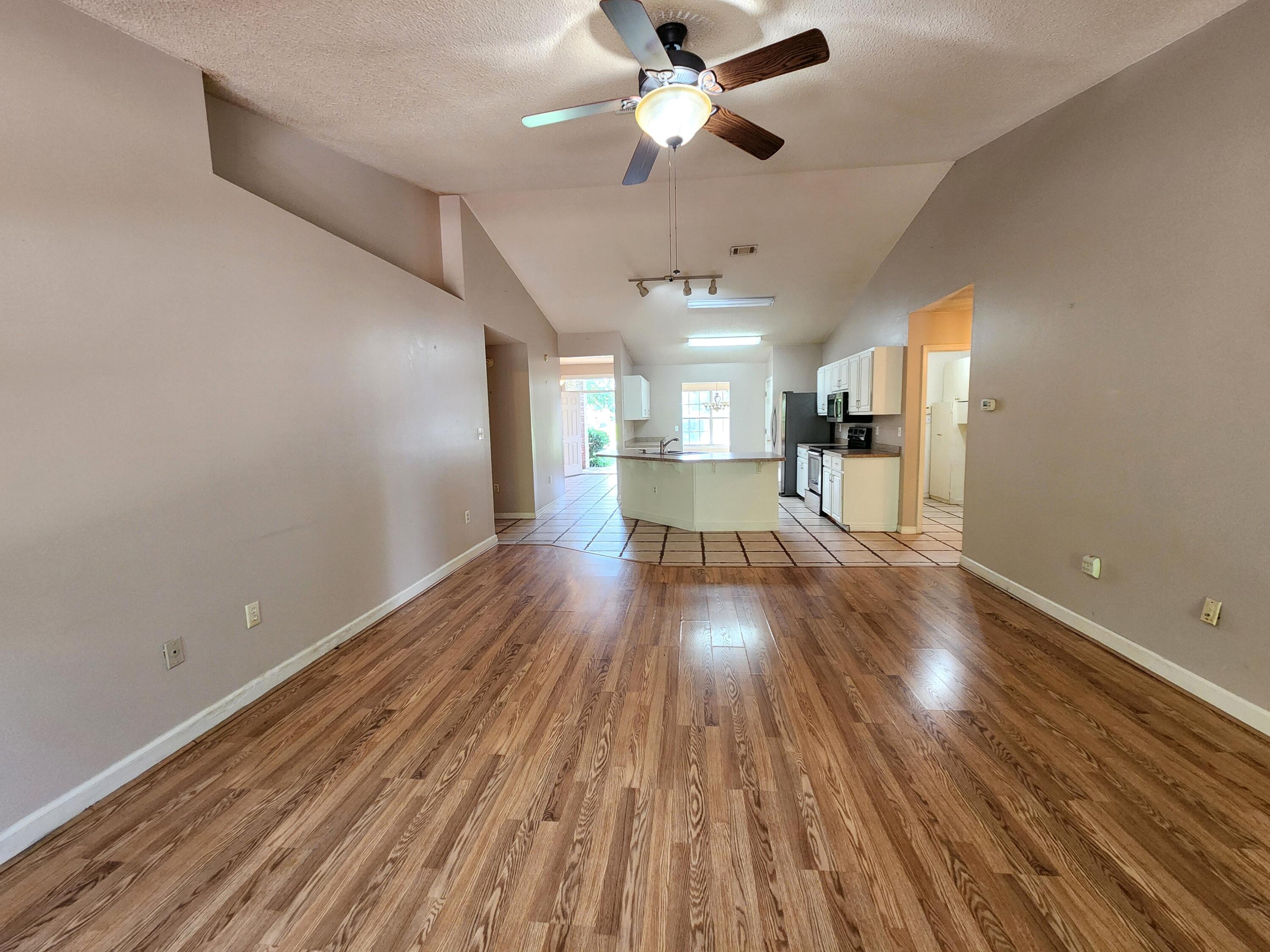 4868 Orlimar Street Crestview, FL 32536 - Photo 16 of 25 a view of empty room with wooden floor