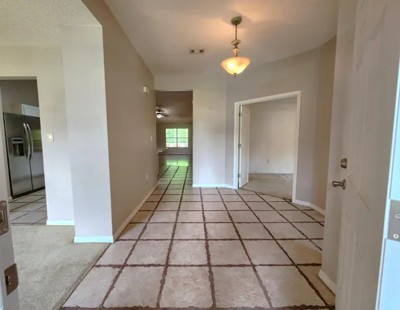 a view of an empty room and fire place