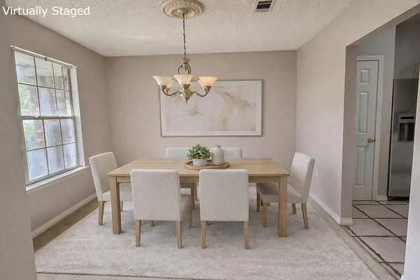 a view of a dining room with furniture window and outside view