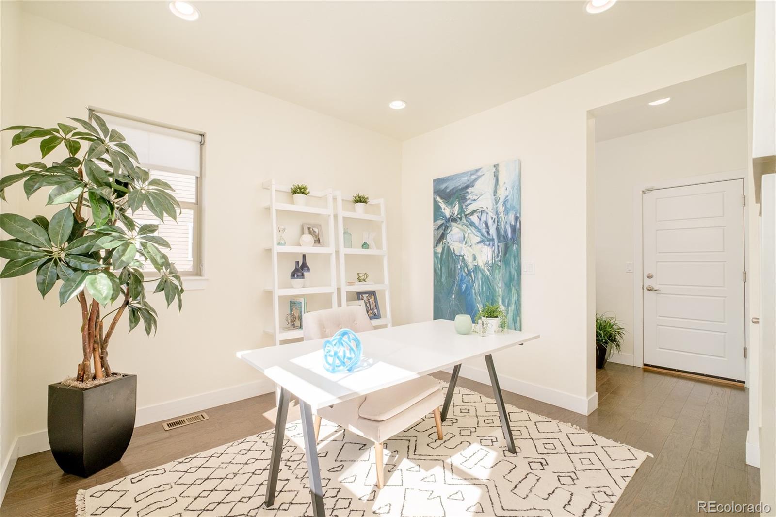 11880 West 38th Place Wheat Ridge, CO 80033 - Photo 12 of 30 a view of a livingroom with furniture and wooden floor