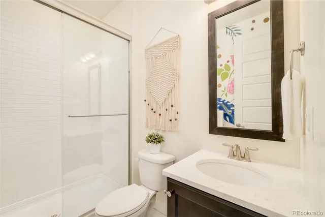 a bathroom with a sink a toilet and shower curtain