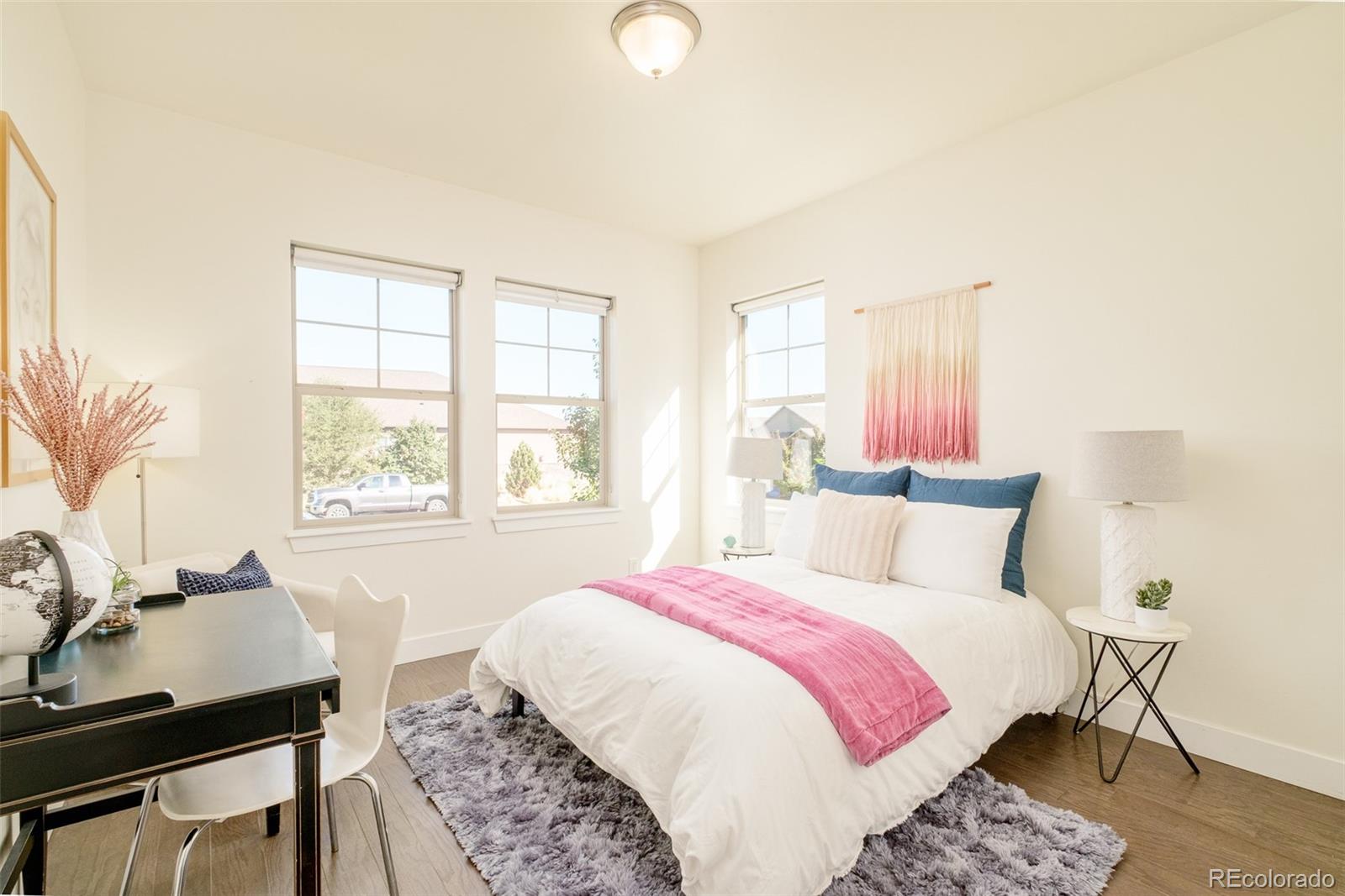 11880 West 38th Place Wheat Ridge, CO 80033 - Photo 16 of 30 a bedroom with a bed and a table