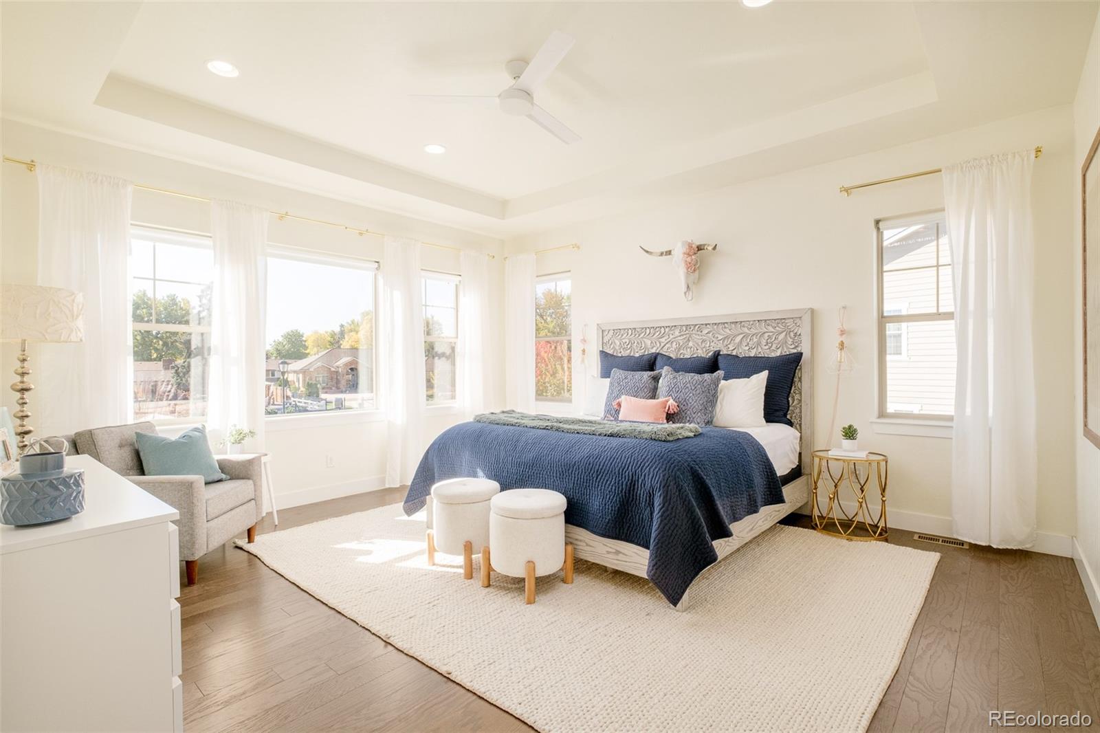 11880 West 38th Place Wheat Ridge, CO 80033 - Photo 19 of 30 a bedroom with a bed and large windows