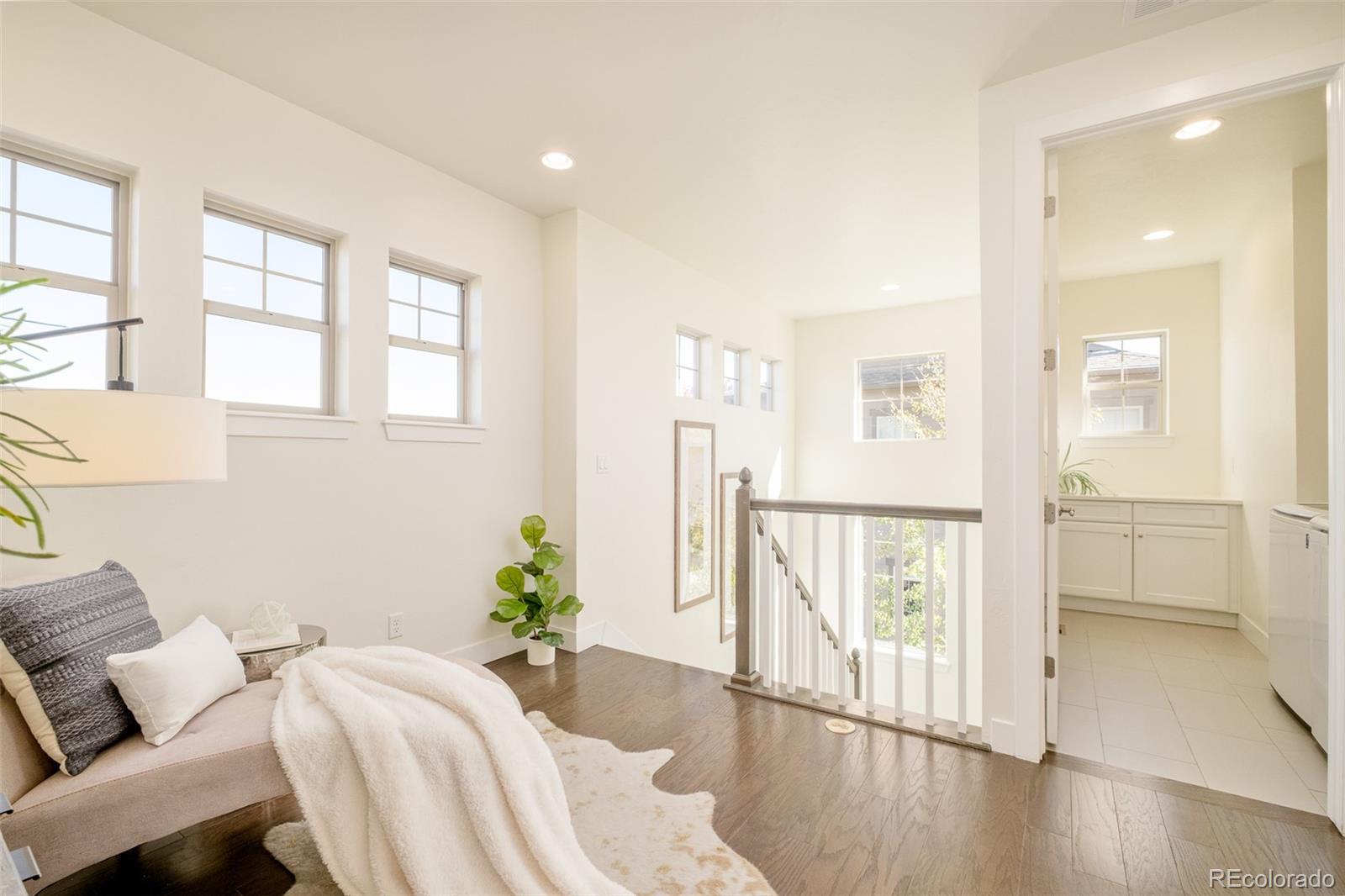11880 West 38th Place Wheat Ridge, CO 80033 - Photo 25 of 30 a spacious bedroom with a balcony a bed and a window