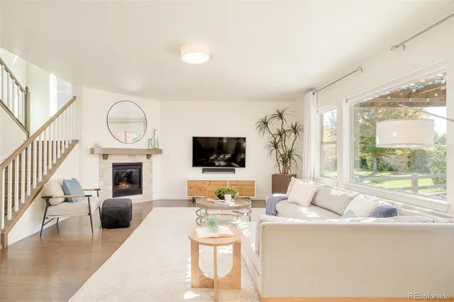 a living room with furniture fireplace and flat screen tv