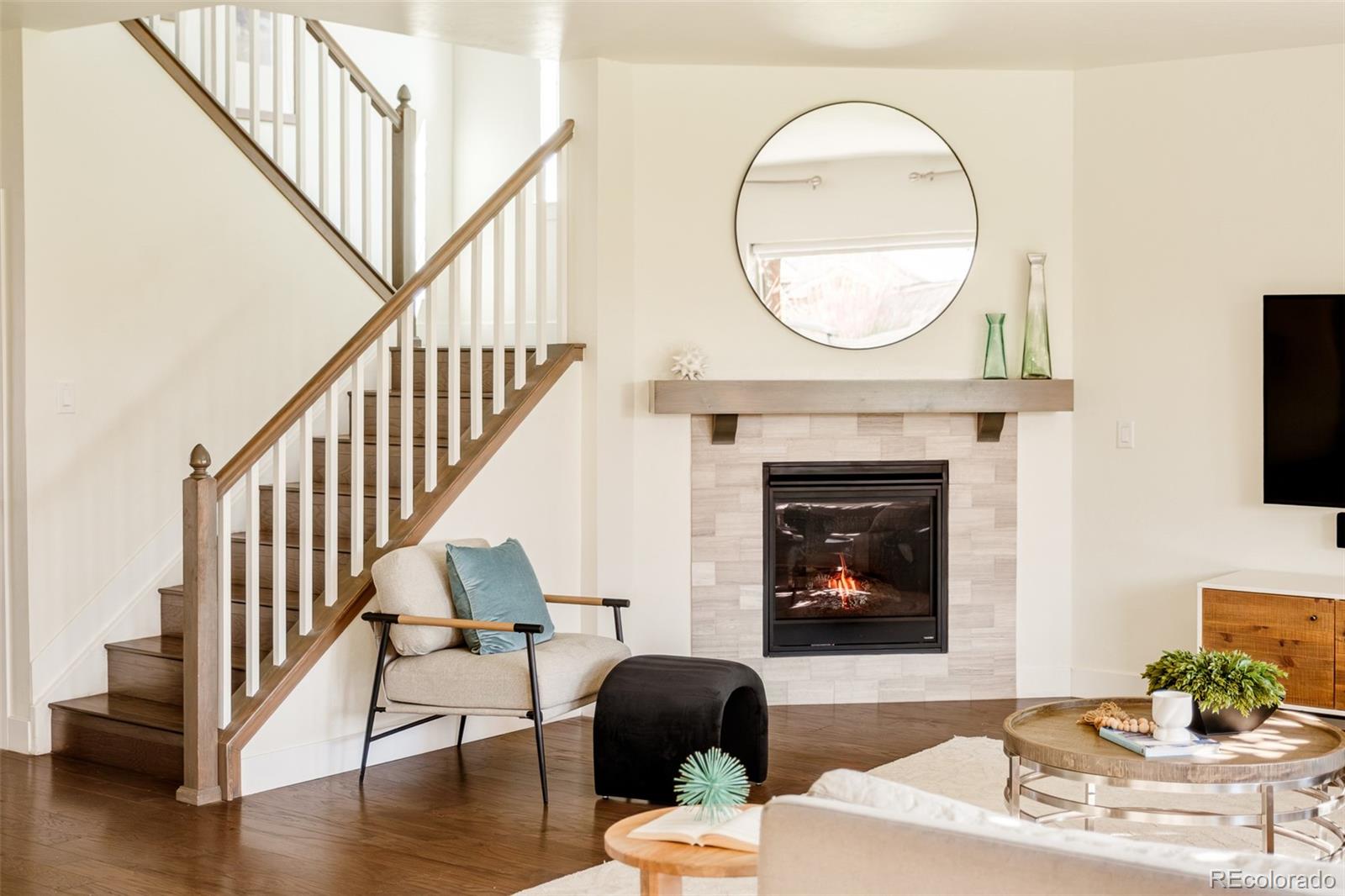 11880 West 38th Place Wheat Ridge, CO 80033 - Photo 6 of 30 a living room with furniture a mirror and a fireplace
