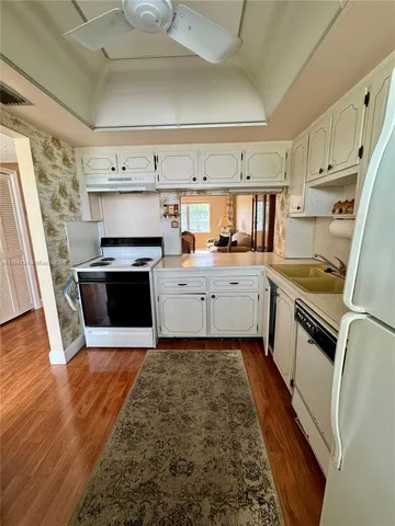 a kitchen with a sink a stove and cabinets