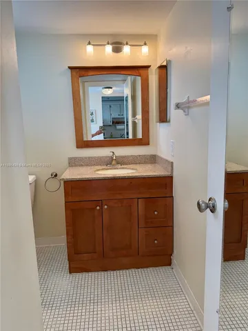 a bathroom with a sink a mirror and vanity