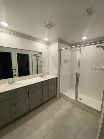 a bathroom with a double vanity sink mirror and double