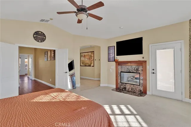 a bedroom with a bed and a television