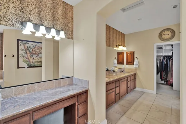 a kitchen with cabinets and wooden floor