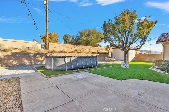 a view of a backyard with wooden fence