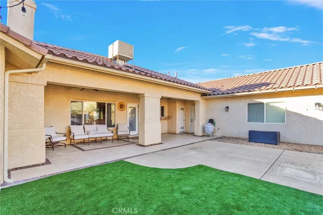 a view of a house with backyard porch and sitting area