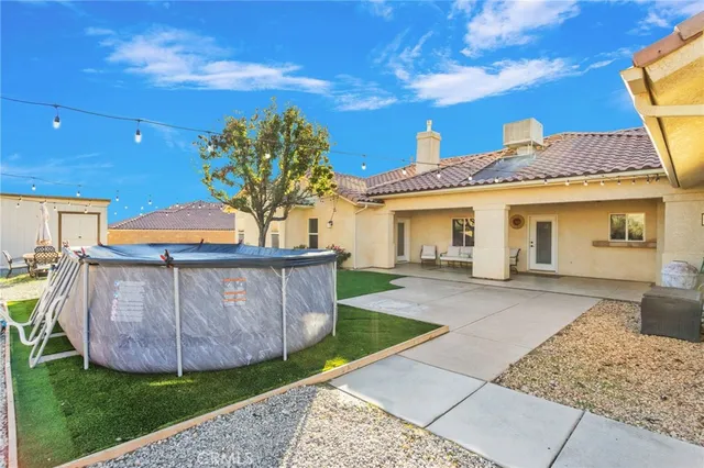 a view of a house with a tub and a yard