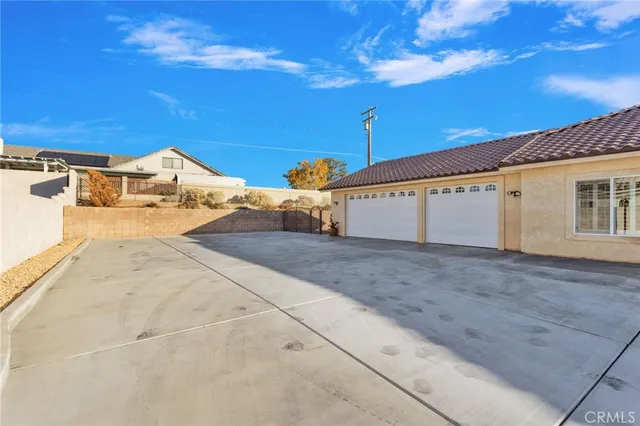 a view of a parking space in front of a house with a road
