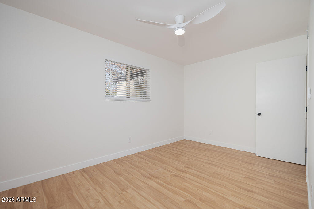 720 South Dobson Road, Unit 85 Mesa, AZ 85202 - Photo 16 of 25 an empty room with wooden floor and windows