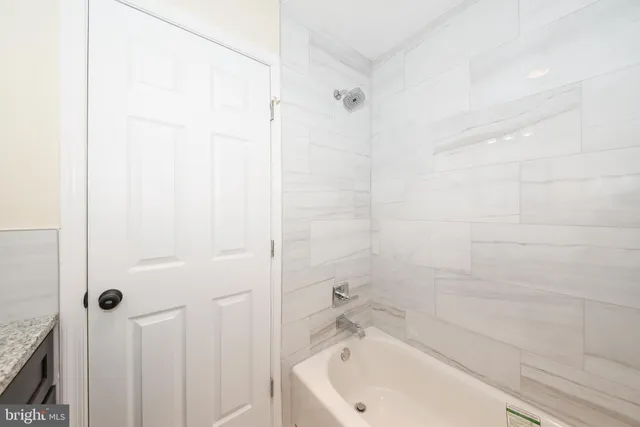 a bathroom with a tub and shower