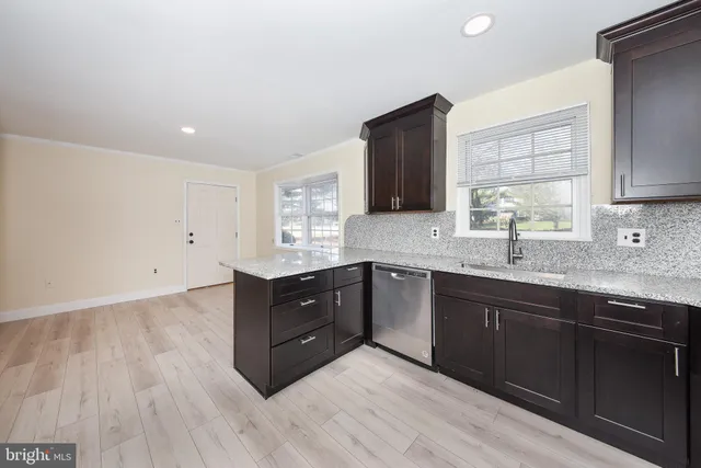 a kitchen with sink and cabinets