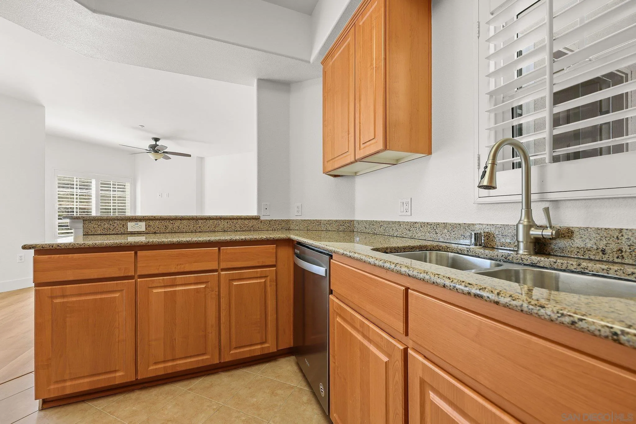 2708 Lake Pointe Drive, Unit 209 Spring Valley, CA 91977 - Photo 12 of 59 a kitchen with granite countertop white cabinets and white appliances