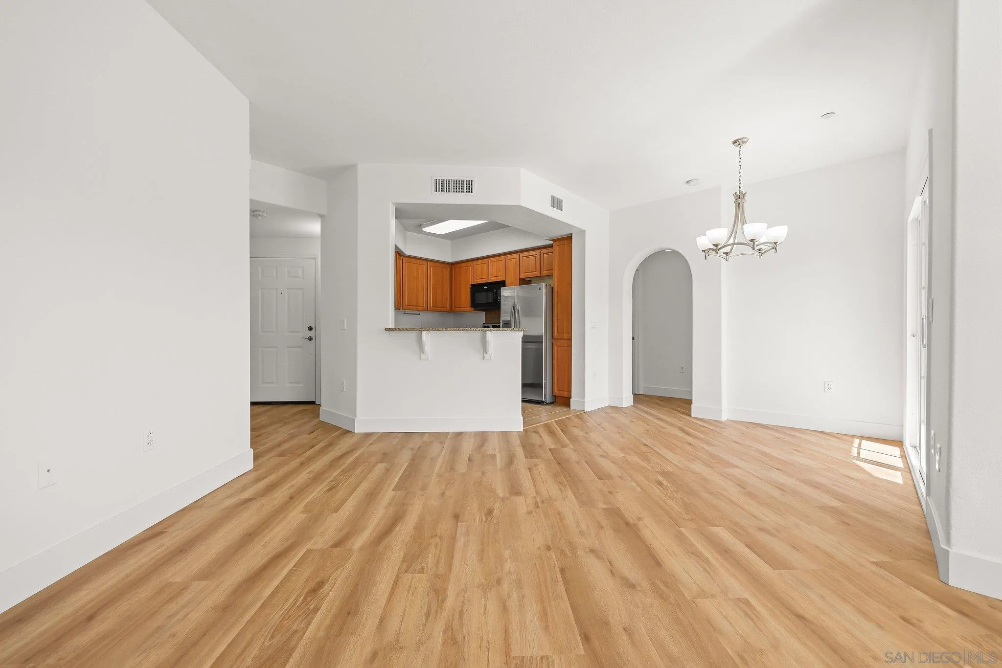 2708 Lake Pointe Drive, Unit 209 Spring Valley, CA 91977 - Photo 13 of 59 a view of a room with wooden floor and a ceiling fan