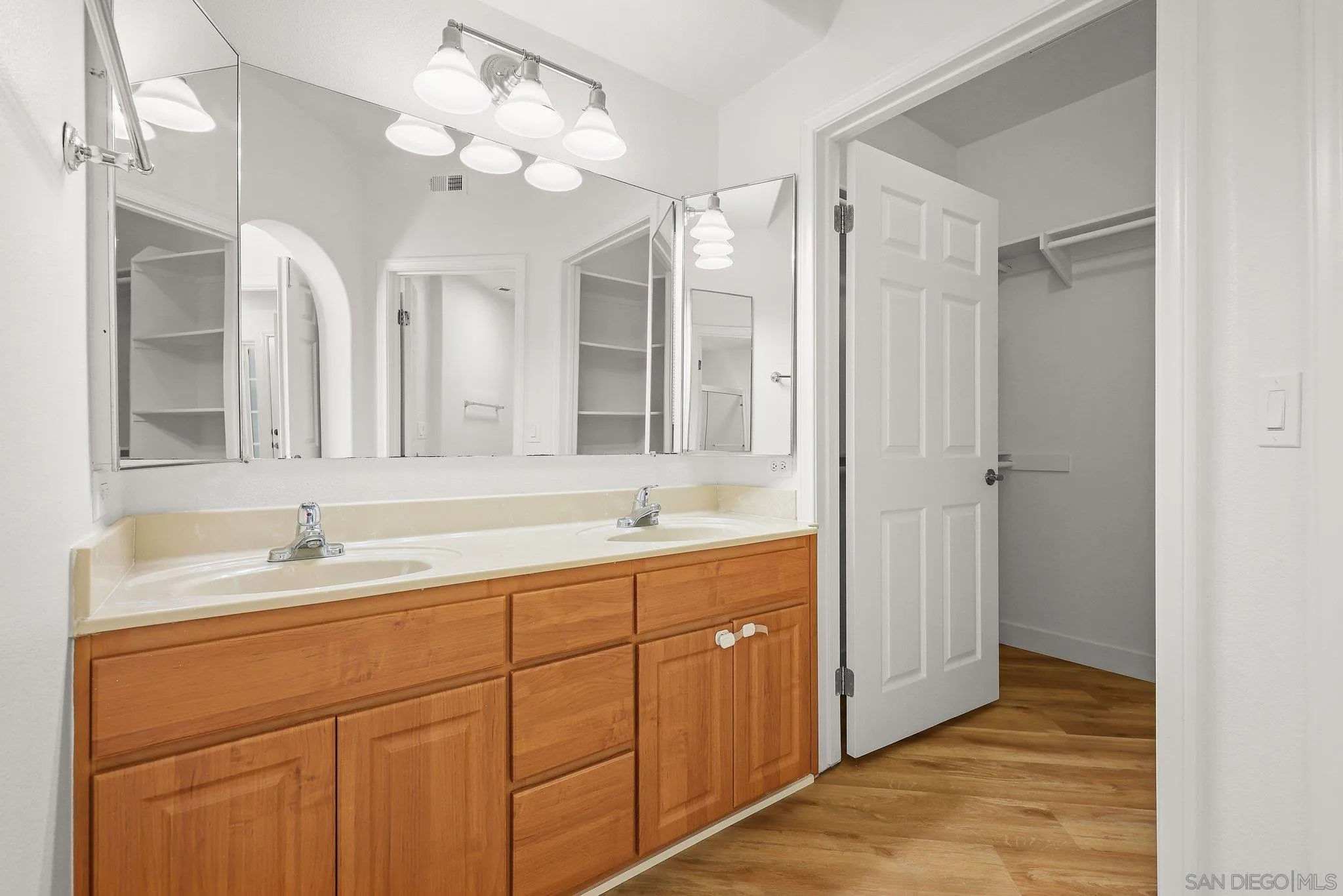 2708 Lake Pointe Drive, Unit 209 Spring Valley, CA 91977 - Photo 25 of 59 a bathroom with a double vanity sink mirror and chandelier