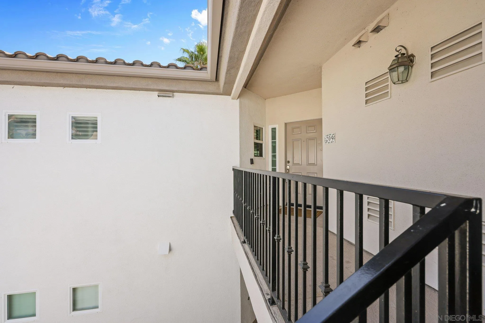 2708 Lake Pointe Drive, Unit 209 Spring Valley, CA 91977 - Photo 39 of 59 a view of staircase with railing and white walls