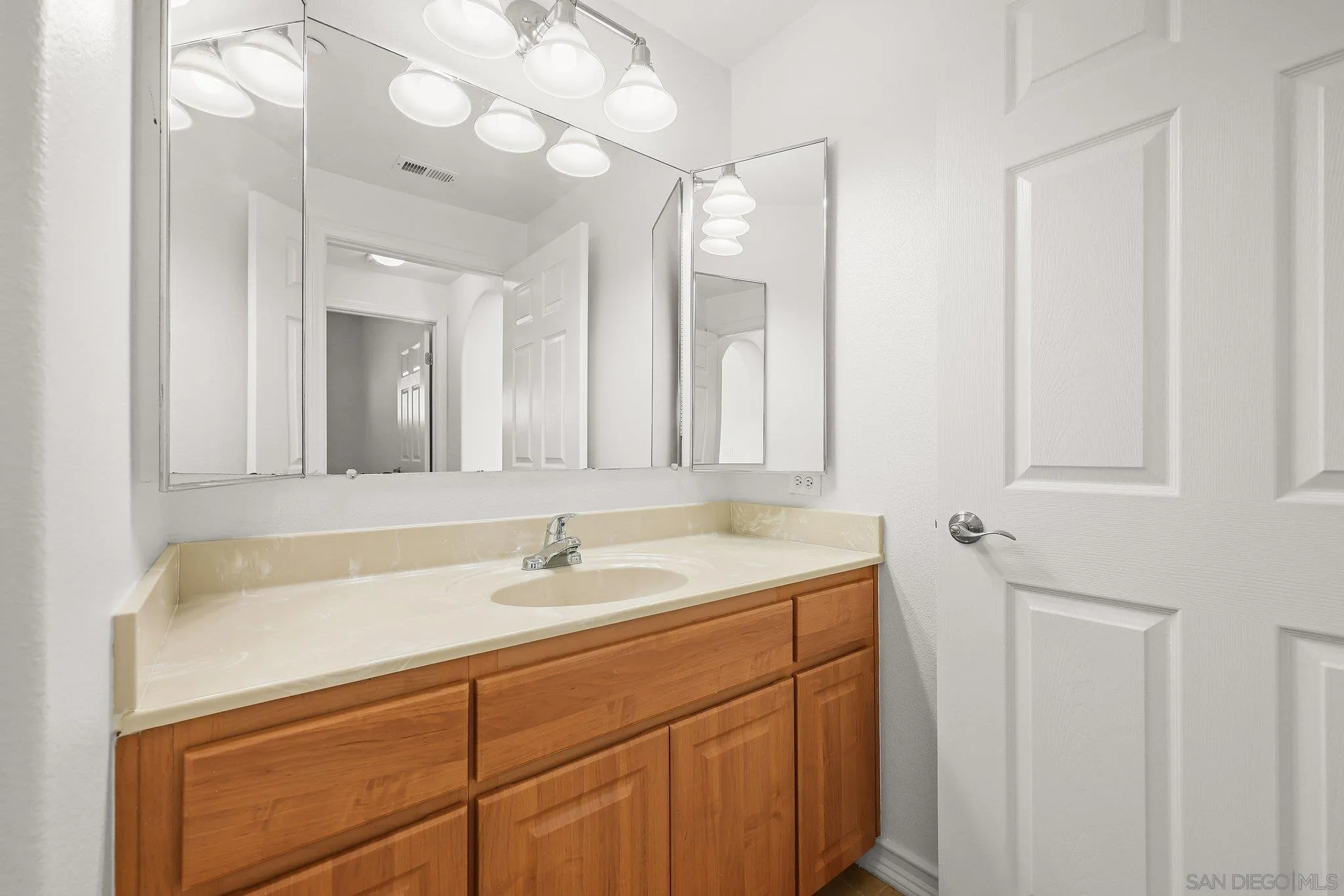 2708 Lake Pointe Drive, Unit 209 Spring Valley, CA 91977 - Photo 42 of 59 a bathroom with a sink and a mirror