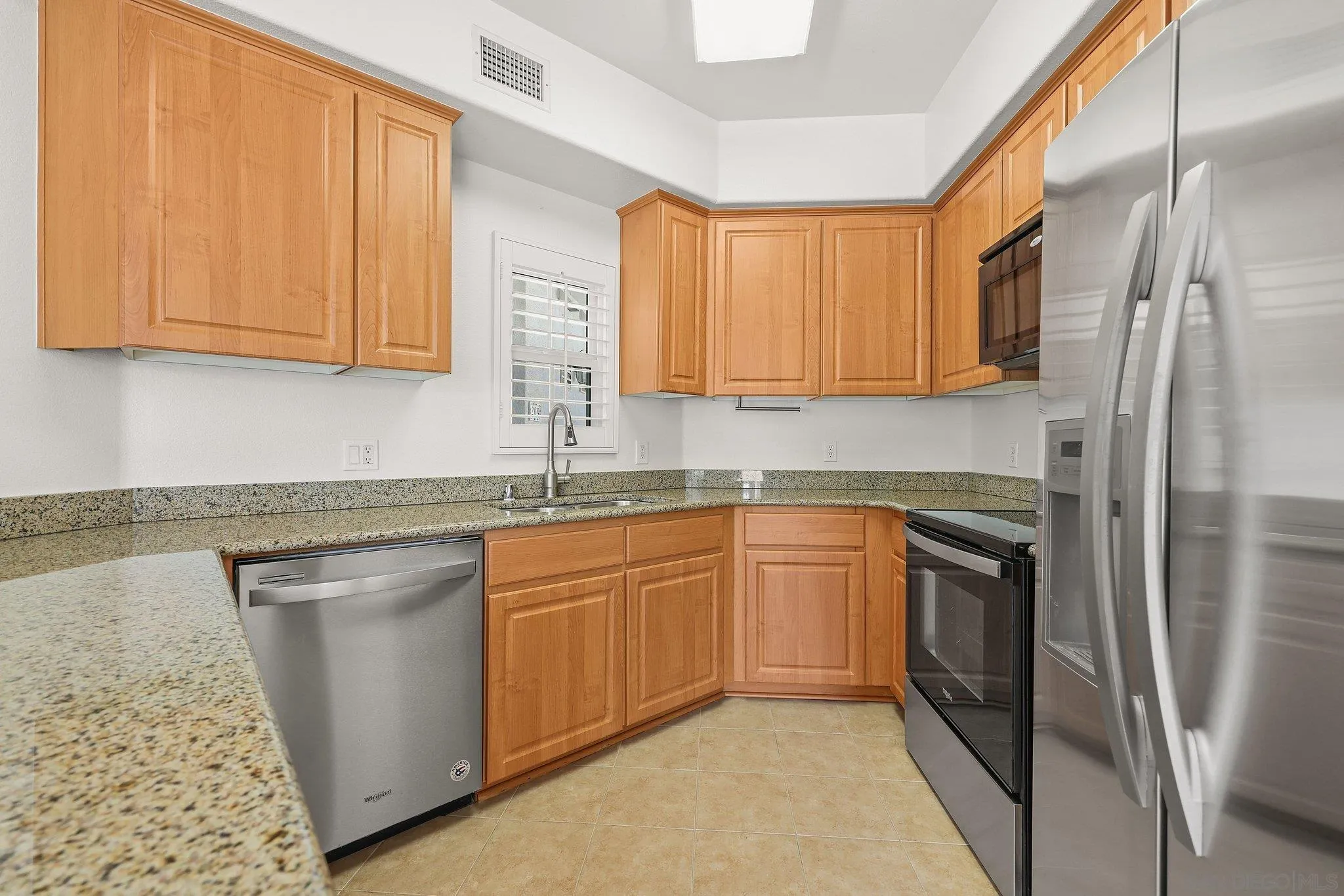 2708 Lake Pointe Drive, Unit 209 Spring Valley, CA 91977 - Photo 5 of 59 a kitchen with stainless steel appliances granite countertop a refrigerator sink and cabinets