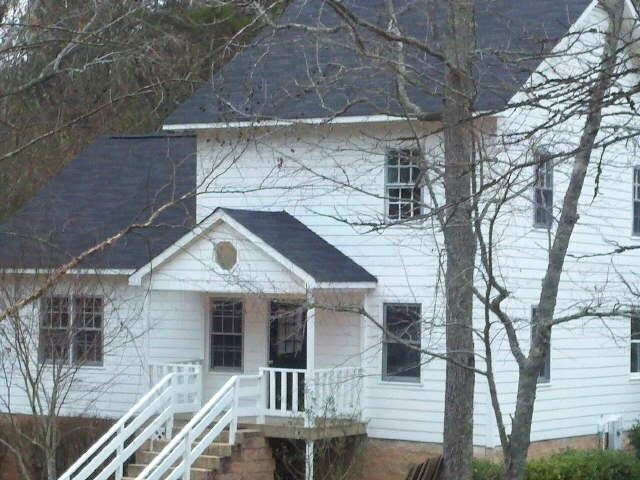 2000 Odum Road Northwest Monroe, GA 30656 - Photo 1 of 1 a front view of a house with stairs