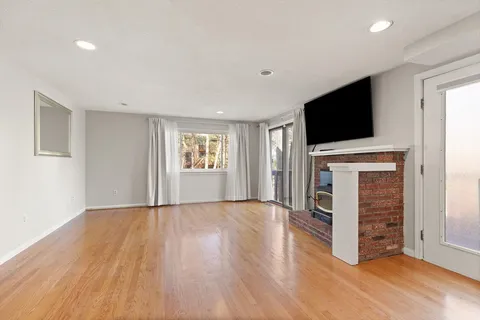 a view of a livingroom with a fireplace and a window