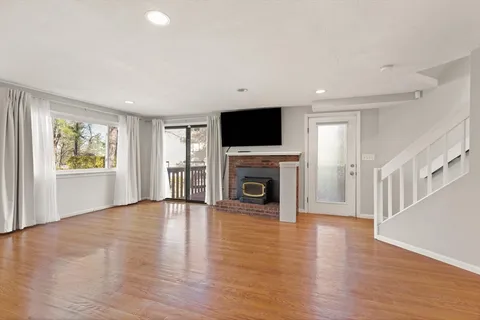 a view of a livingroom with an empty space and a fireplace