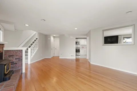 a view of livingroom with hardwood floor and a fireplace