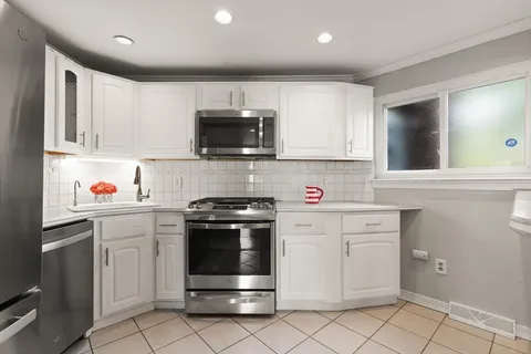 a kitchen with a stove a sink and a microwave