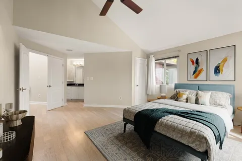 a bedroom with a bed and a painting on the wall