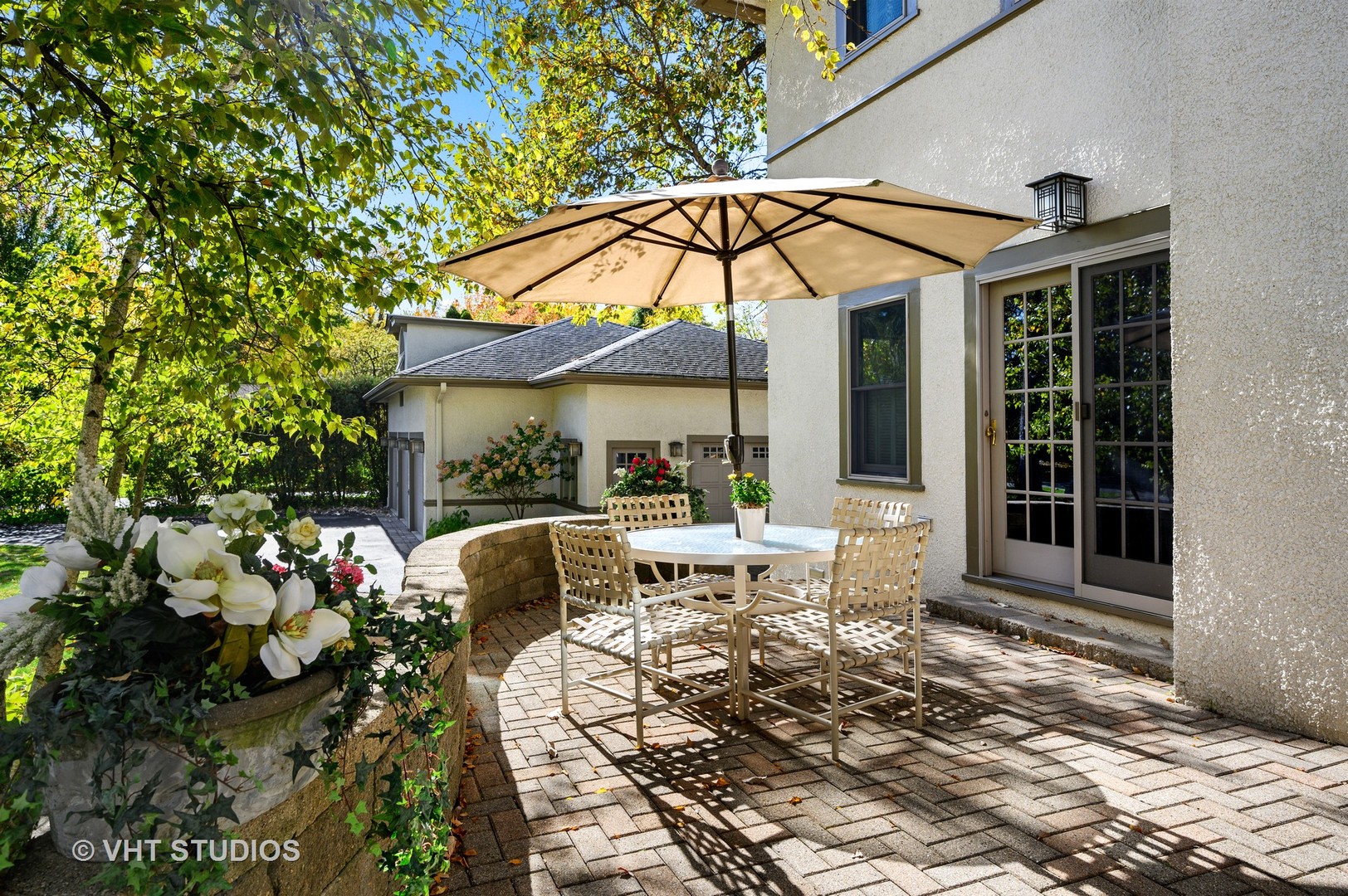 304 Cumnor Road Kenilworth, IL 60043 - Photo 35 of 40 a patio table and chairs under an umbrella