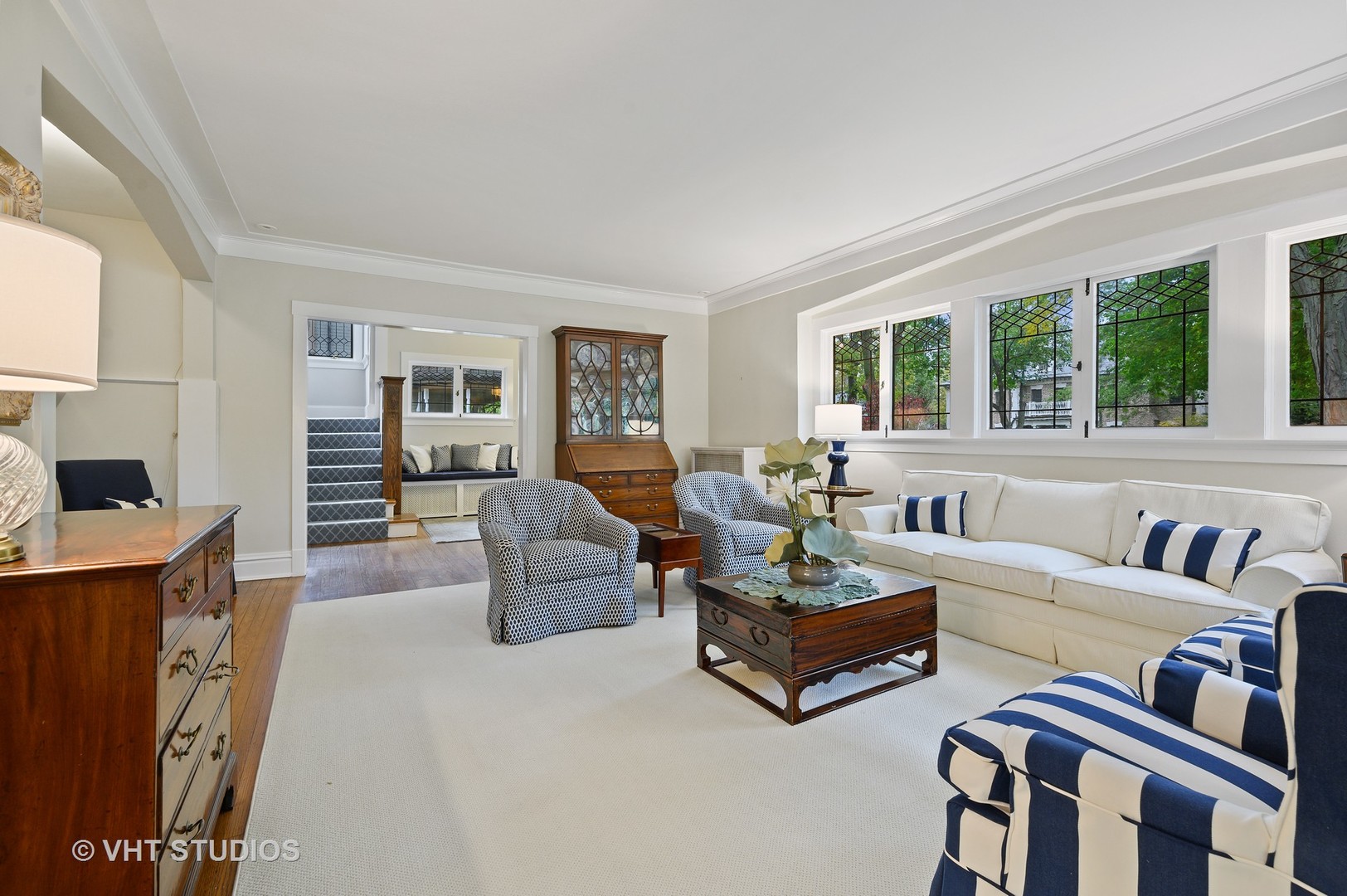 304 Cumnor Road Kenilworth, IL 60043 - Photo 10 of 40 a living room with couches and a large window with garden view