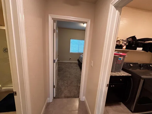 a living room with furniture a flat screen tv and a window
