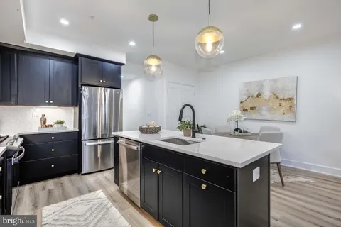 a kitchen with counter top space appliances and cabinets
