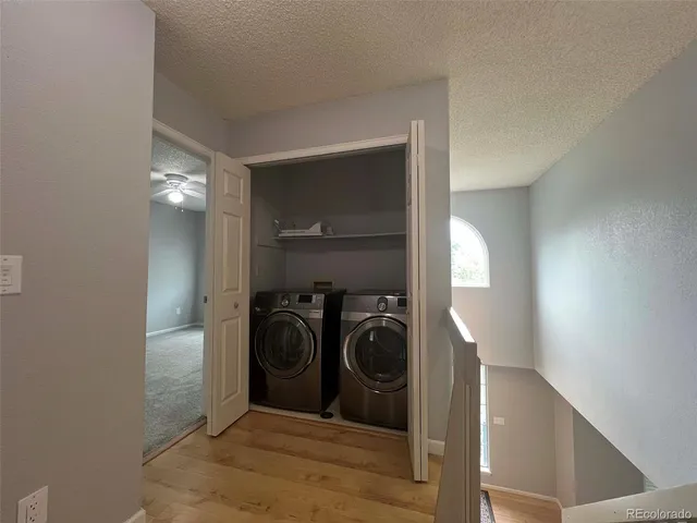 a view of a hallway with closet and a washer