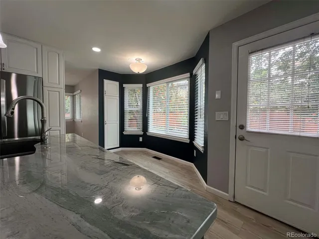 a view of kitchen with windows and refrigerator