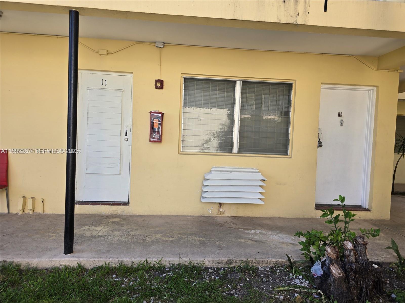 70 Northwest 77th Street, Unit 11 Miami, FL 33150 - Photo 14 of 16 a front view of a house with a yard