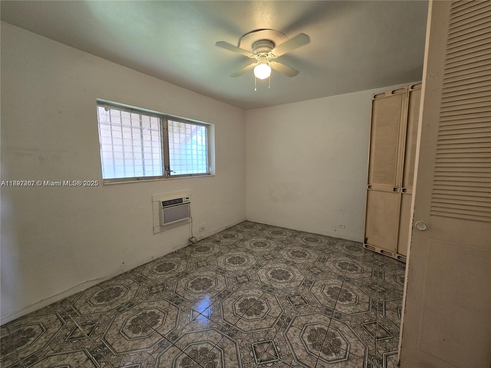 70 Northwest 77th Street, Unit 11 Miami, FL 33150 - Photo 8 of 17 a view of a hallway with a chandelier fan